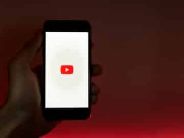 Hand Holding Smartphone with Internet Access to YouTube