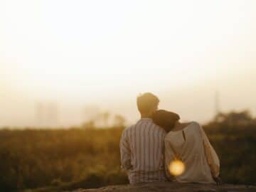Man and Woman Near Grass Field