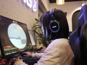 a person wearing headphones sitting in front of a computer