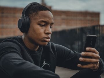 man in black nike hoodie wearing black headphones