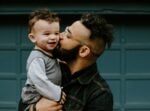 man carrying baby boy and kissing on cheek. what to say to someone who lost a parent