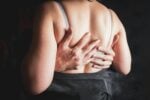 Hands embracing a woman's back