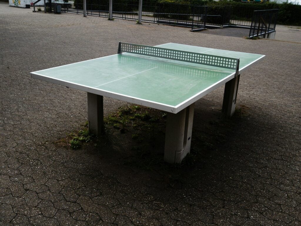 Outdoor ping pong table with net on asphalt
