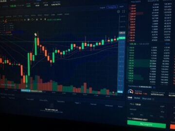 A digital candlestick chart showing cryptocurrency market trends on a dark computer screen